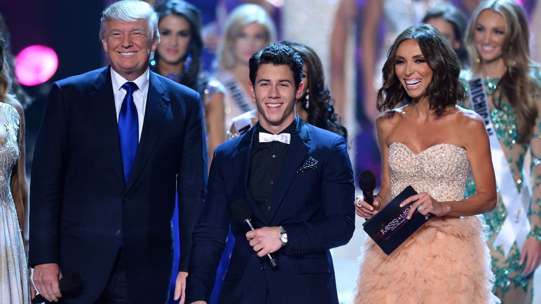 Trump appears on stage with singer Nick Jonas and television personality Giuliana Rancic during the 2013 Miss USA pageant.