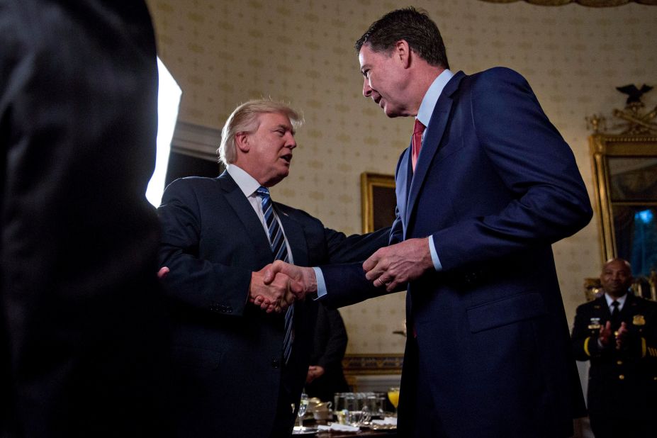Trump shakes hands with FBI Director James Comey during a White House reception in January 2017. <a href=