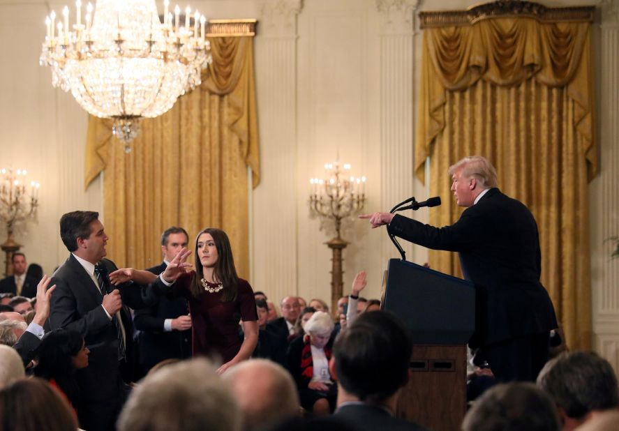 A White House staff member reaches for the microphone held by CNN's Jim Acosta as he questions Trump during a news conference in November 2018. Later that day, in a stunning break with protocol, the White House said that it was <a href=