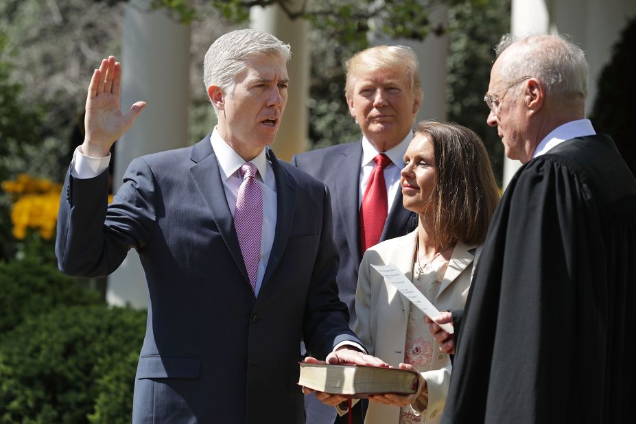 Trump watches as Supreme Court Justice Anthony Kennedy, right, administers the judicial oath to Neil Gorsuch during <a href=