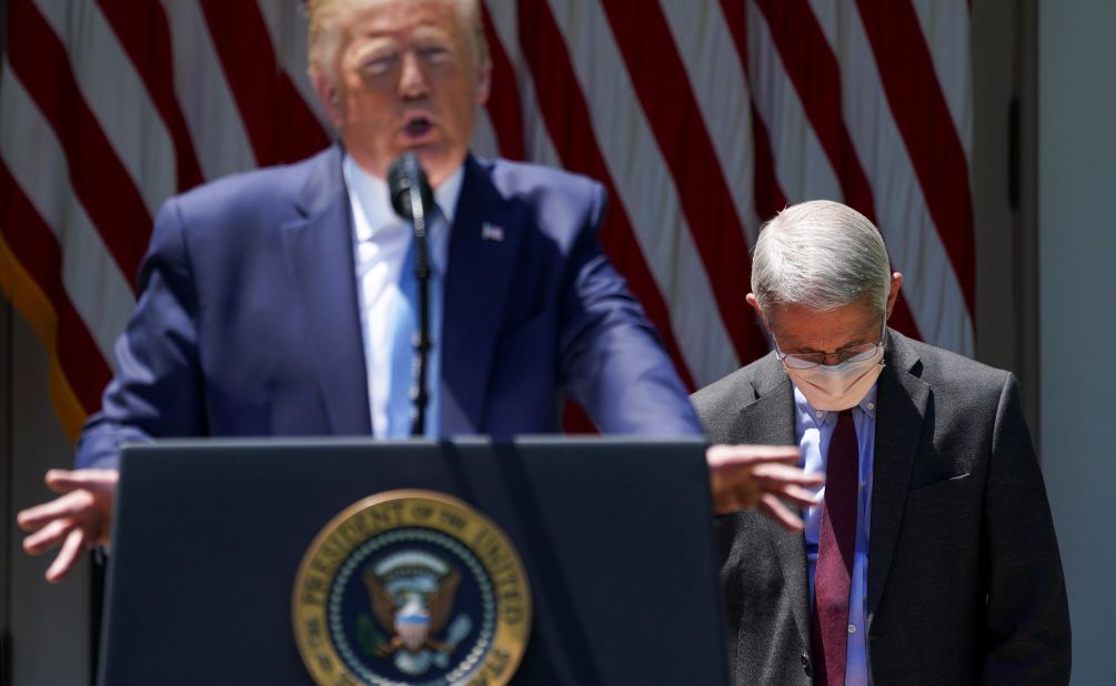 Dr. Anthony Fauci looks down as Trump speaks in the White House Rose Garden in May 2020. Trump was unveiling <a href=